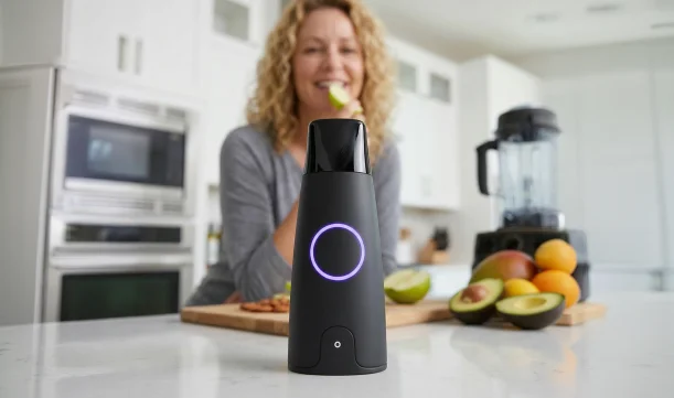 Woman using Lumen metabolism tracker device in her kitchen